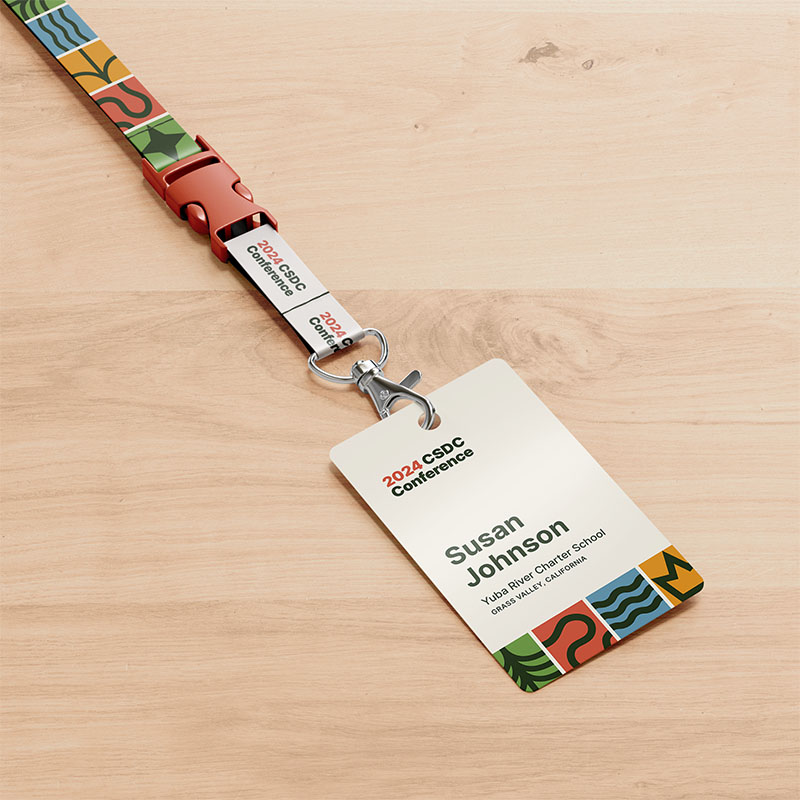 An identification badge for Susan Johnson, paired with a colorful lanyard. It's set against a wooden table.