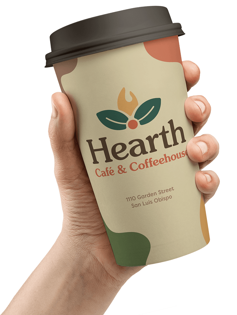 Hearth's new to-go cup held in a hand against a blurry bokeh background